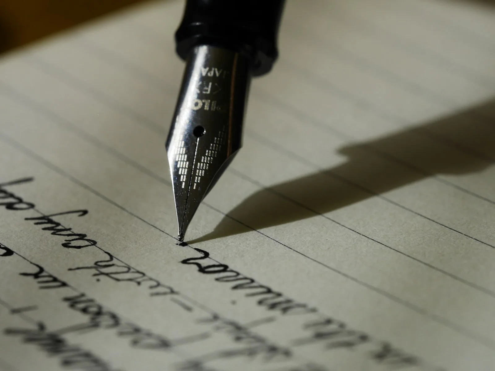 Notebook with handwritten notes and a pen on a desk, representing guided study routines