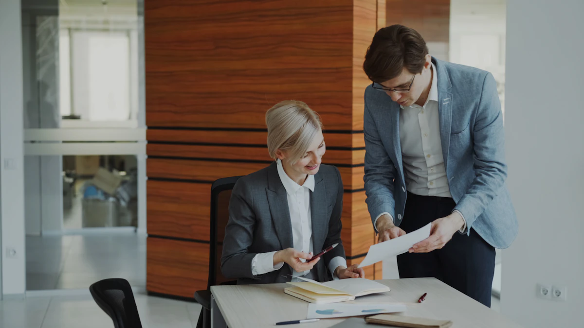 Two professionals comparing documents to decide how to organize them