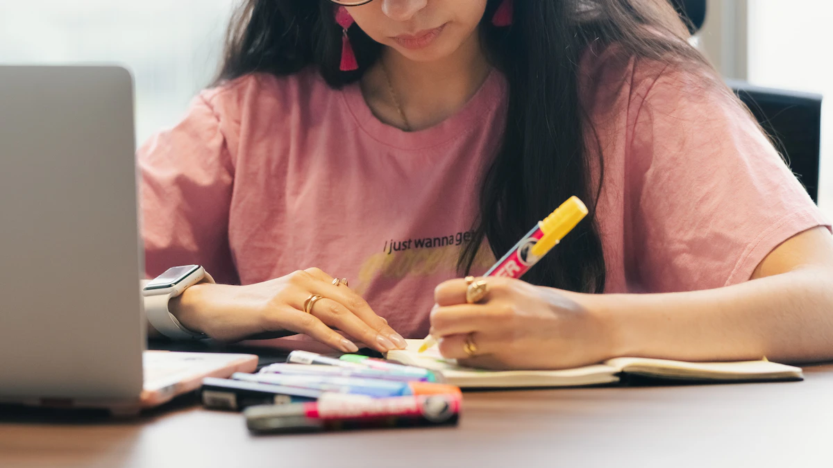 Student using a computer and notebook to verify and process information